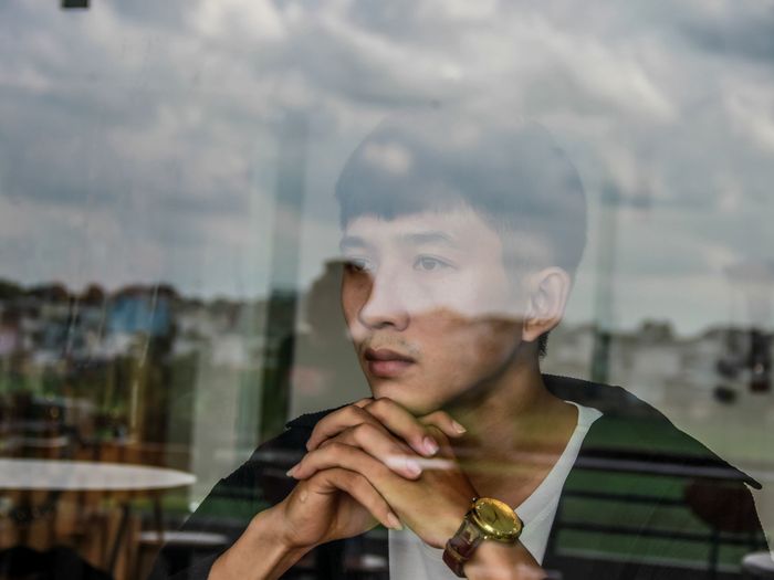 Black-and-white profile of a thoughtful young man